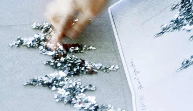 Close-up of intricate silver and black embroidery work at Atelier Montex